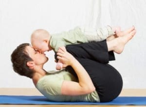 Mom does yoga or Pilates with baby