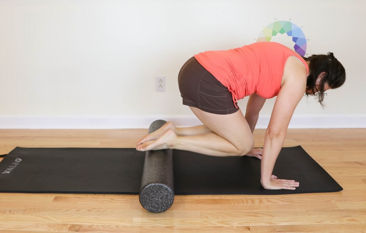 using a foam roller to massage the top of the feet