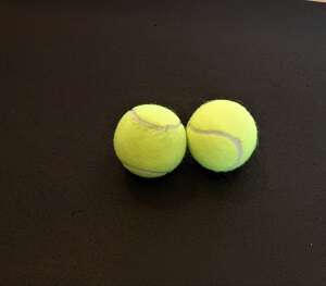 picture of two tennis balls to help relieve back pain